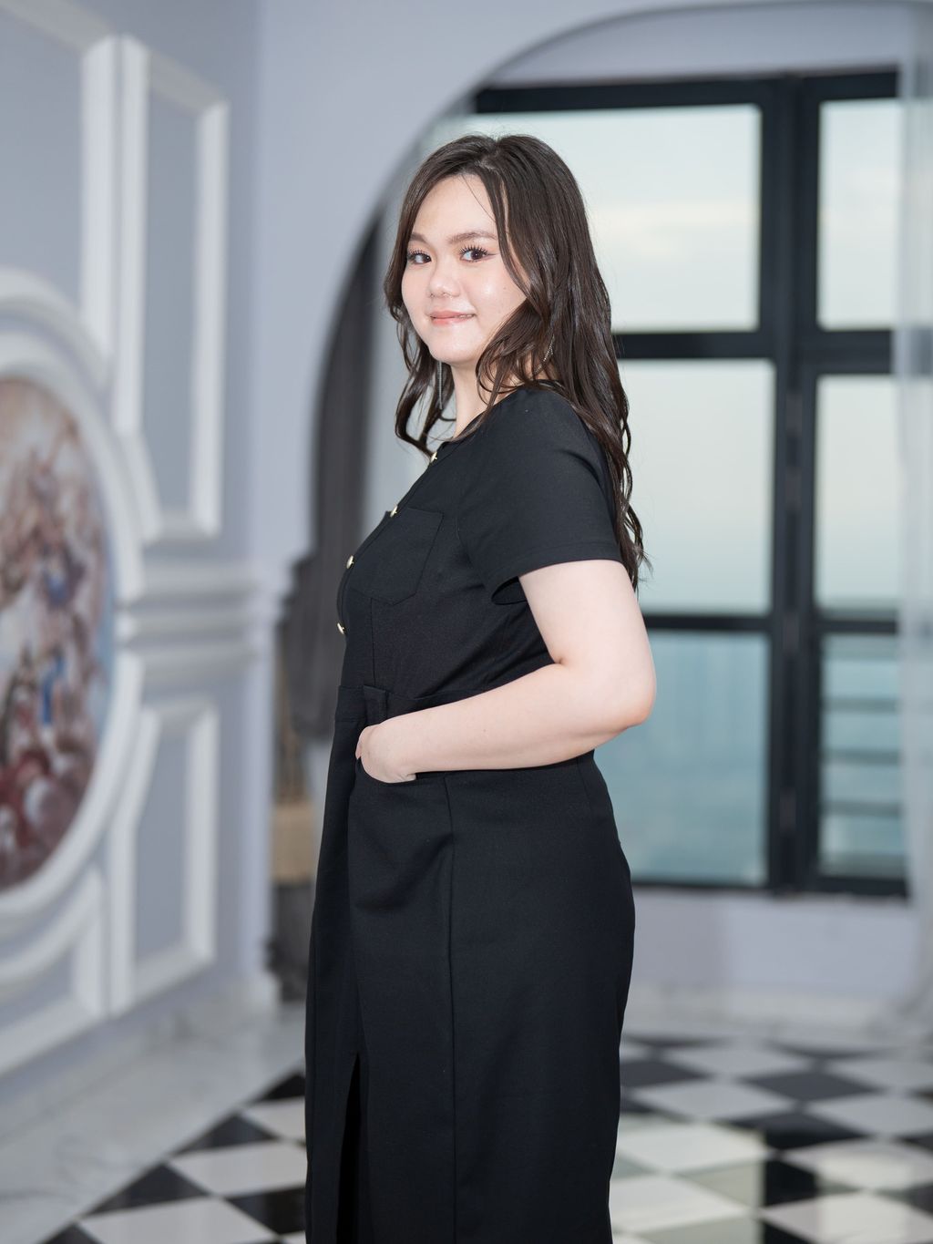 Side pose showing gold buttons and defined waist of green plus-size dress.