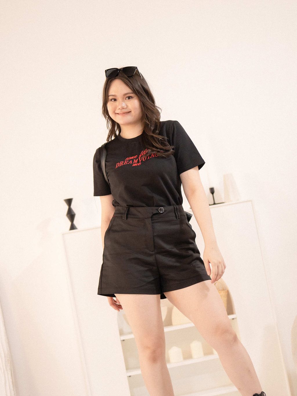 Plus-size woman wearing high-waisted black tailored shorts