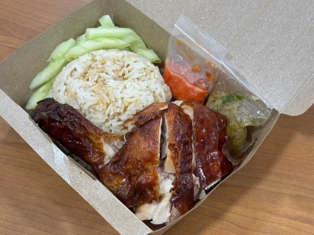 Hainanese roasted chicken with steamed chicken rice in compact one-compartment packaging