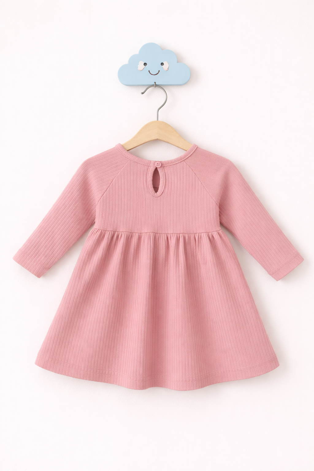 Pink ribbed baby dress on display