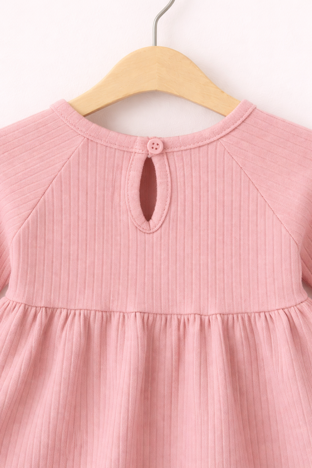 Close-up of pink baby dress detail