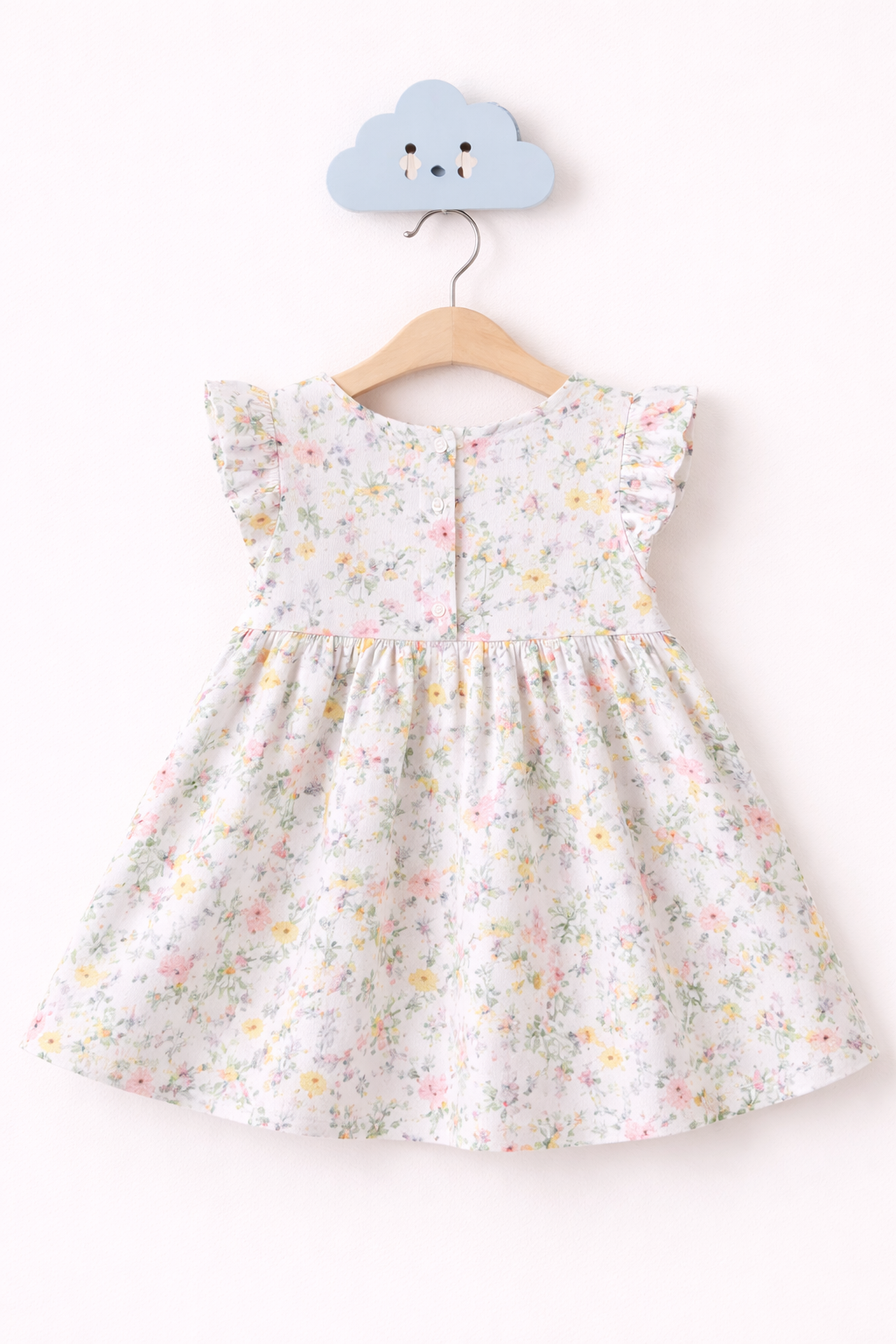 Pastel floral dress on hanger