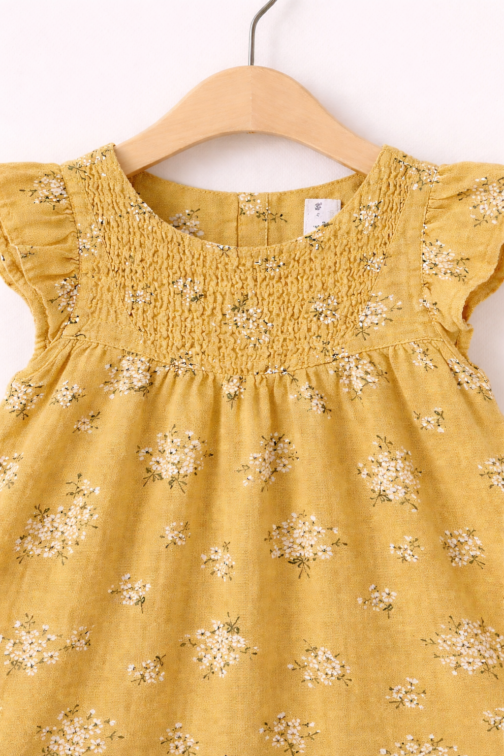 Mustard yellow baby dress detail