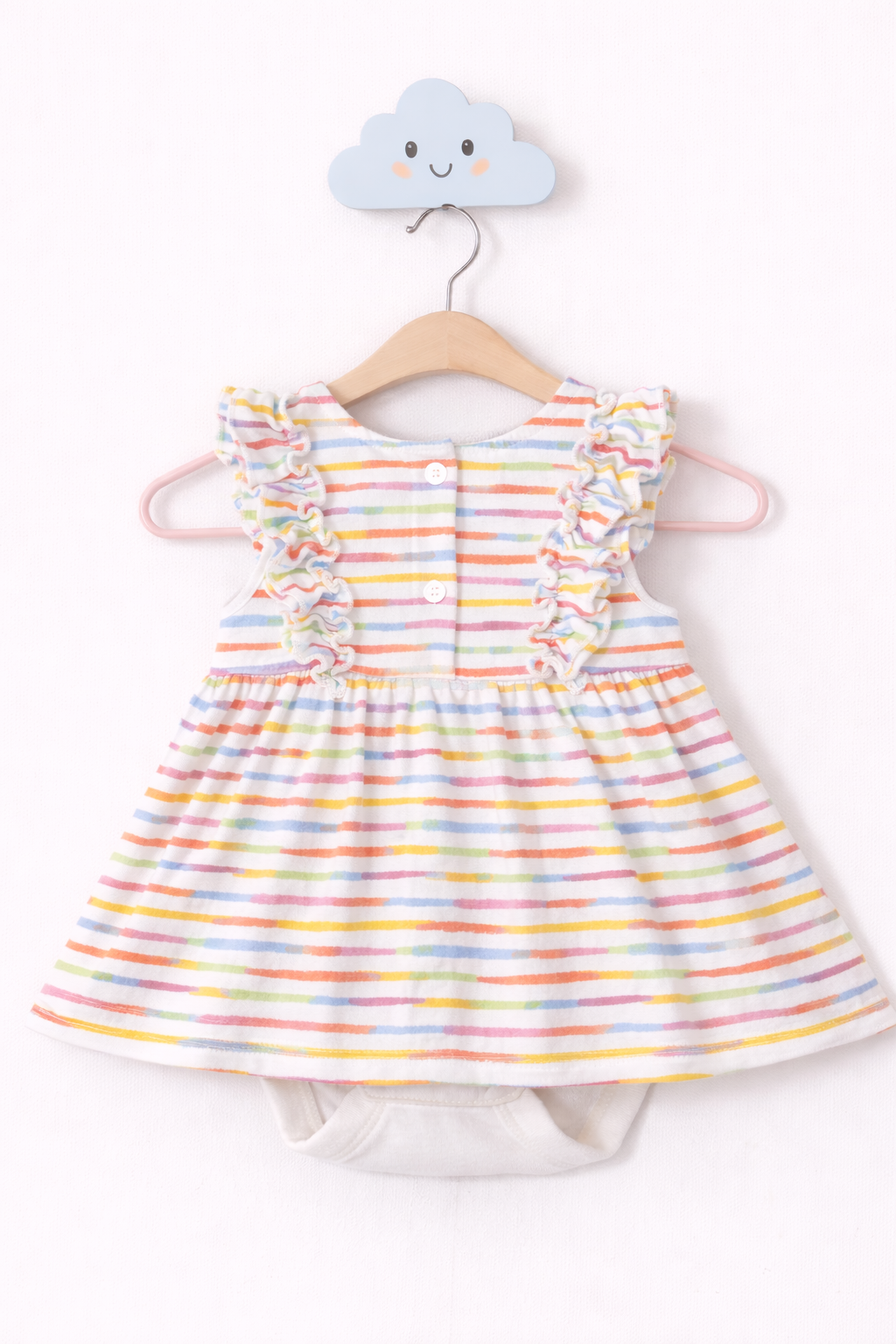 Pastel striped baby dress on hook