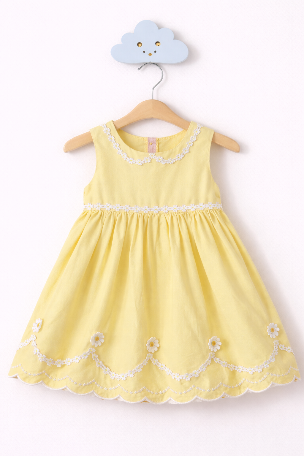 Delicate daisy dress on wooden hanger