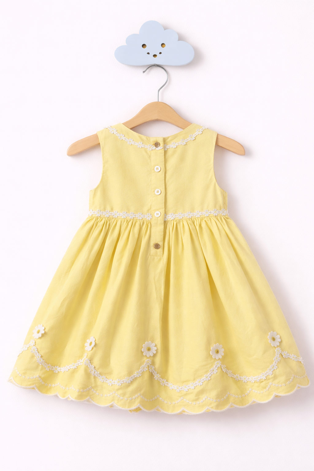 Pale yellow girl's dress with daisies