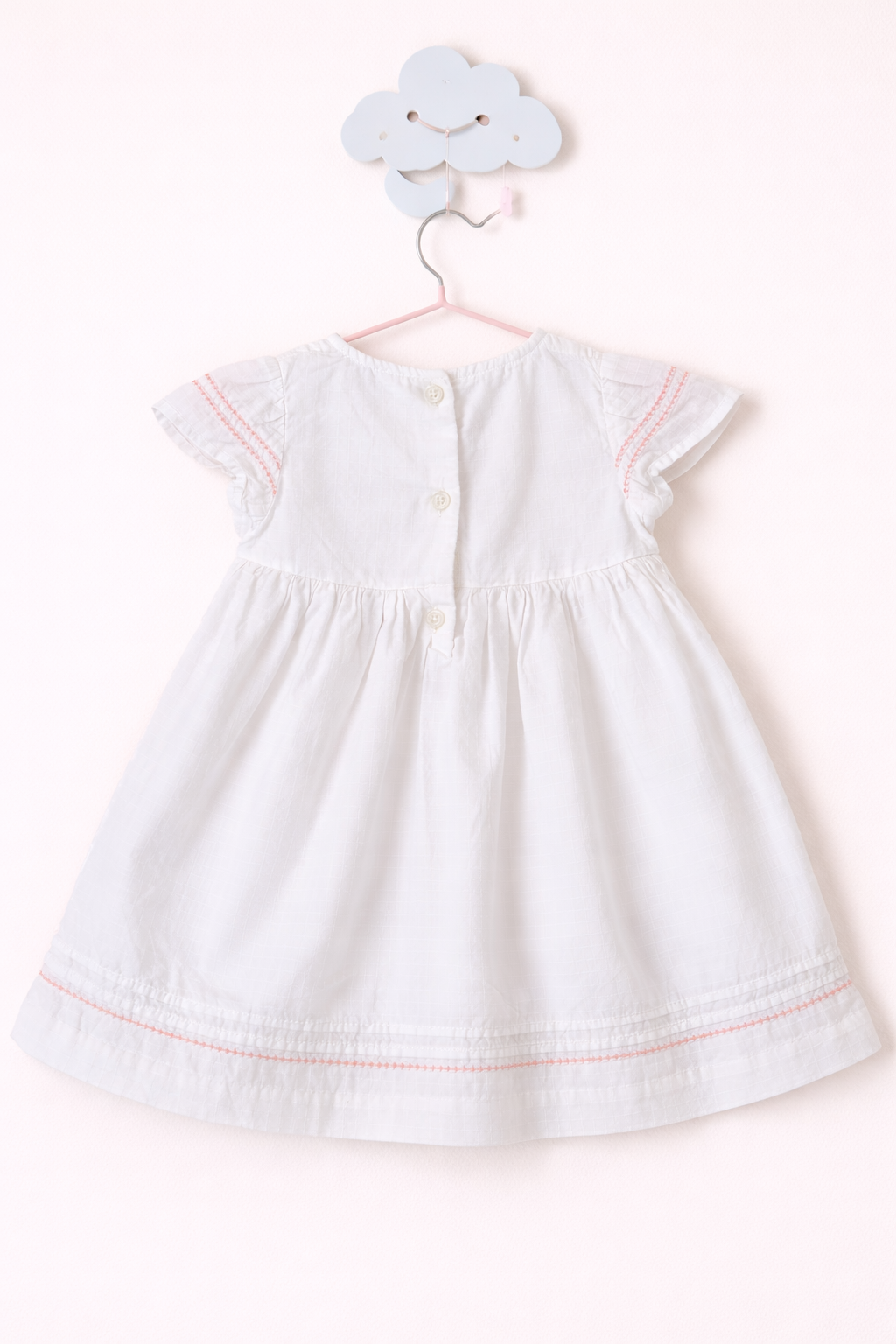 Delicate baby dress on cloud hook