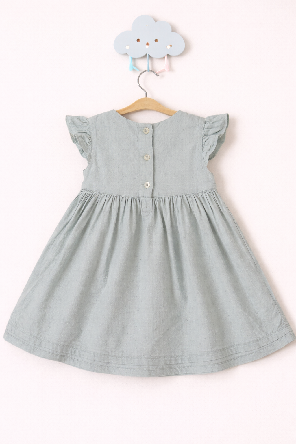 Delicate sage dress on soft backdrop