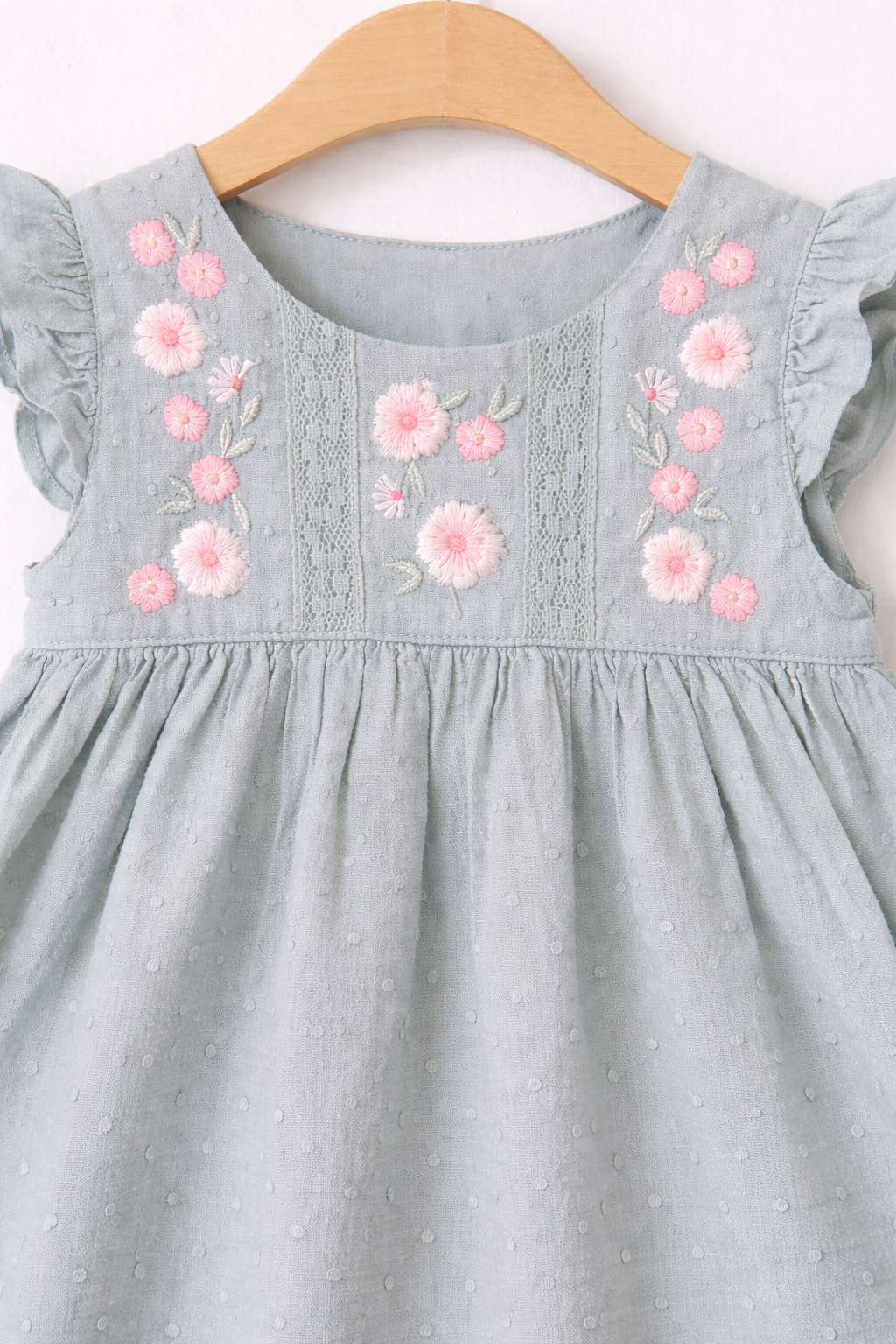 Delicate floral embroidery on green dress