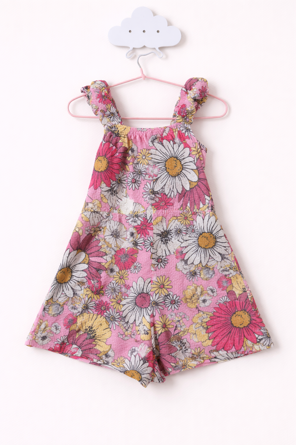Floral romper hanging on cloud hook