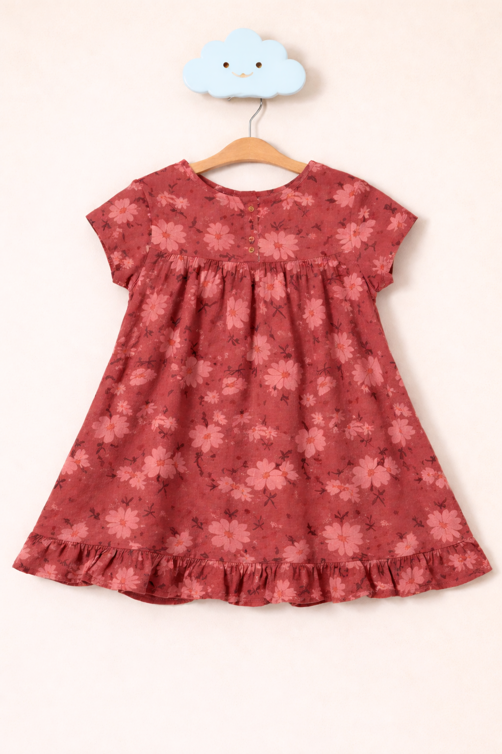 Dusty rose floral dress on hook