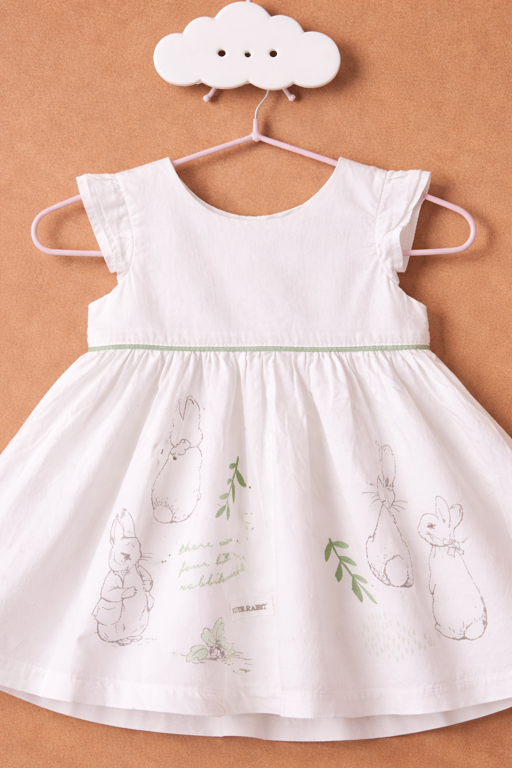 Delicate children's dress on pastel hook