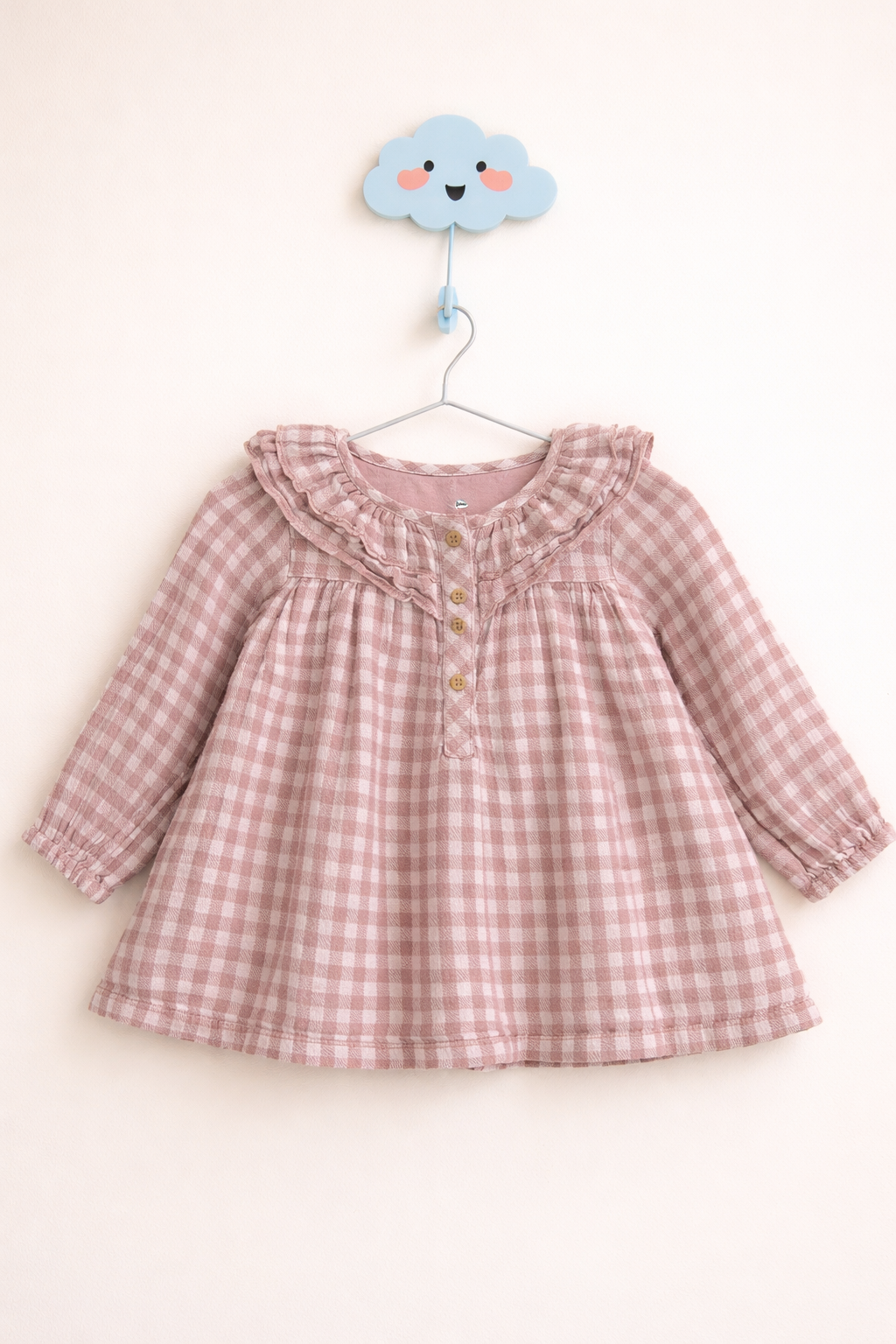 Soft gingham blouse on wall hook
