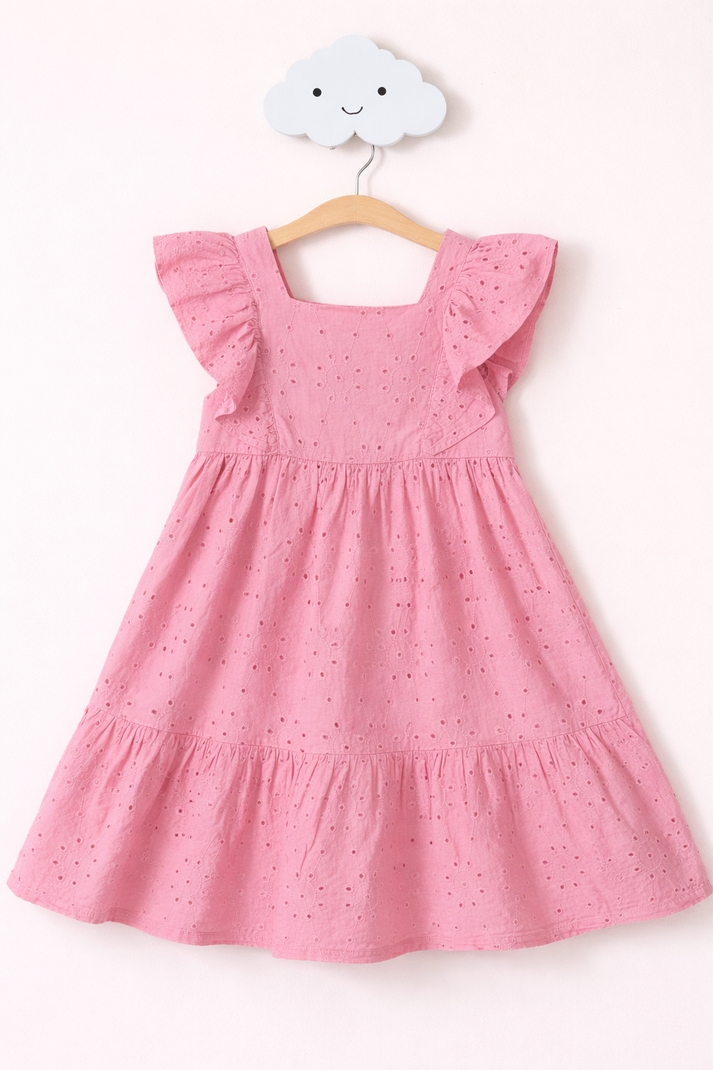 Delicate pink eyelet sundress hanging