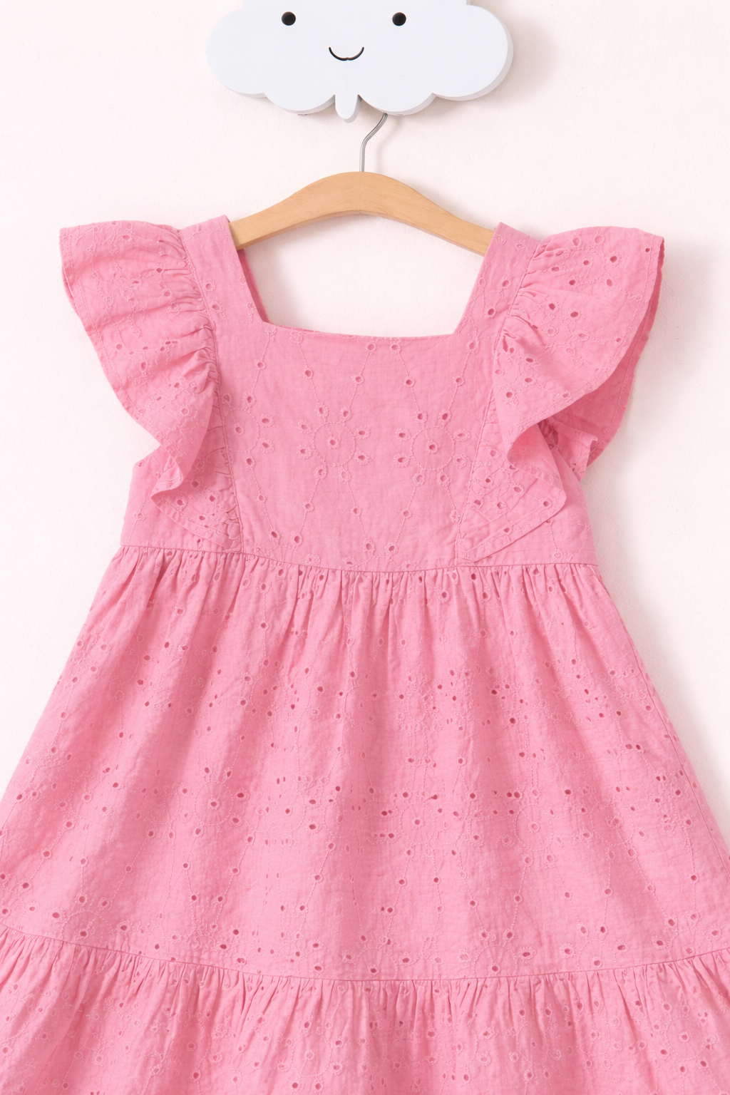 Pastel pink eyelet dress close-up
