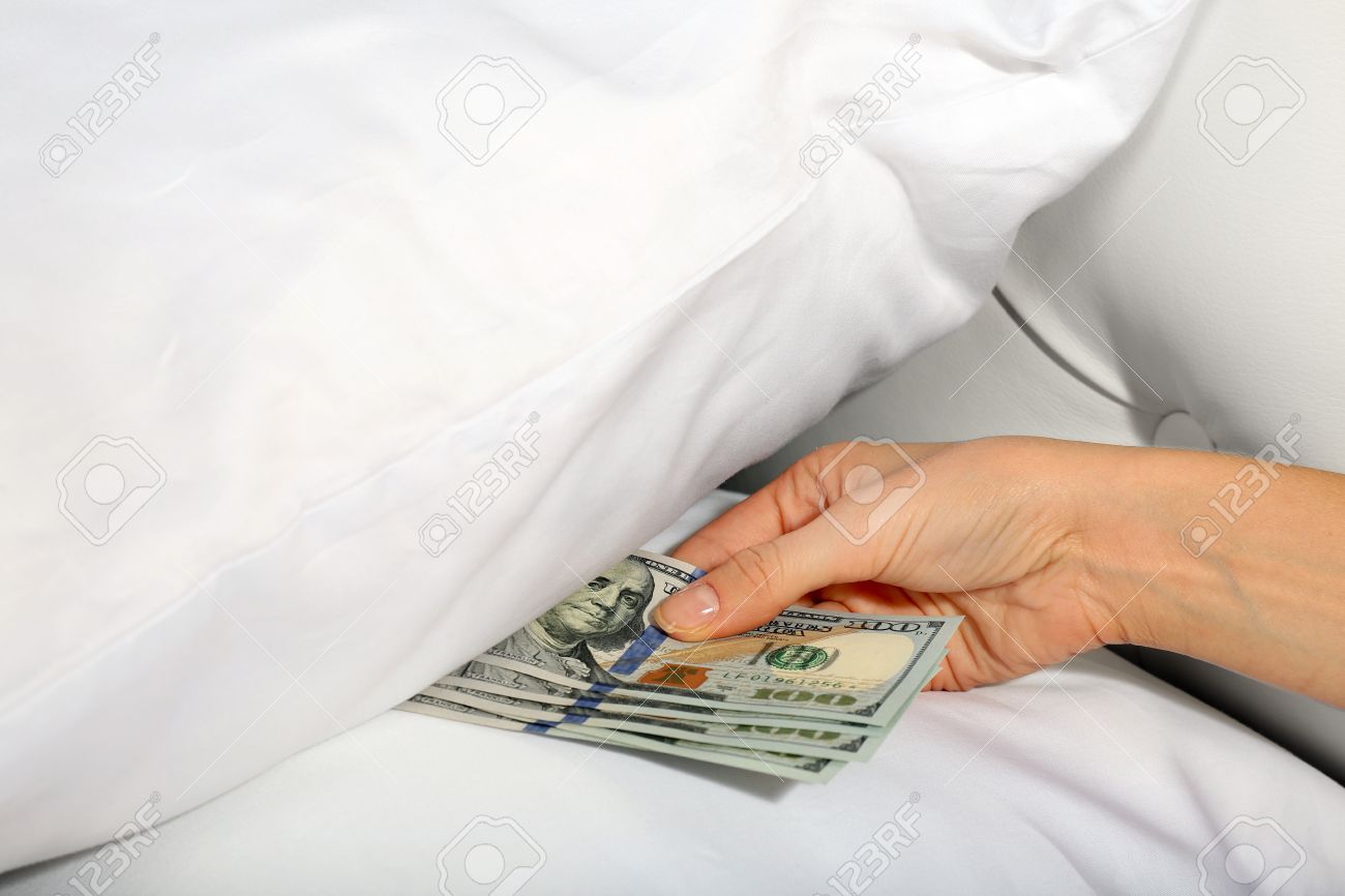 32986381-woman-hiding-money-under-pillow-at-home.jpg