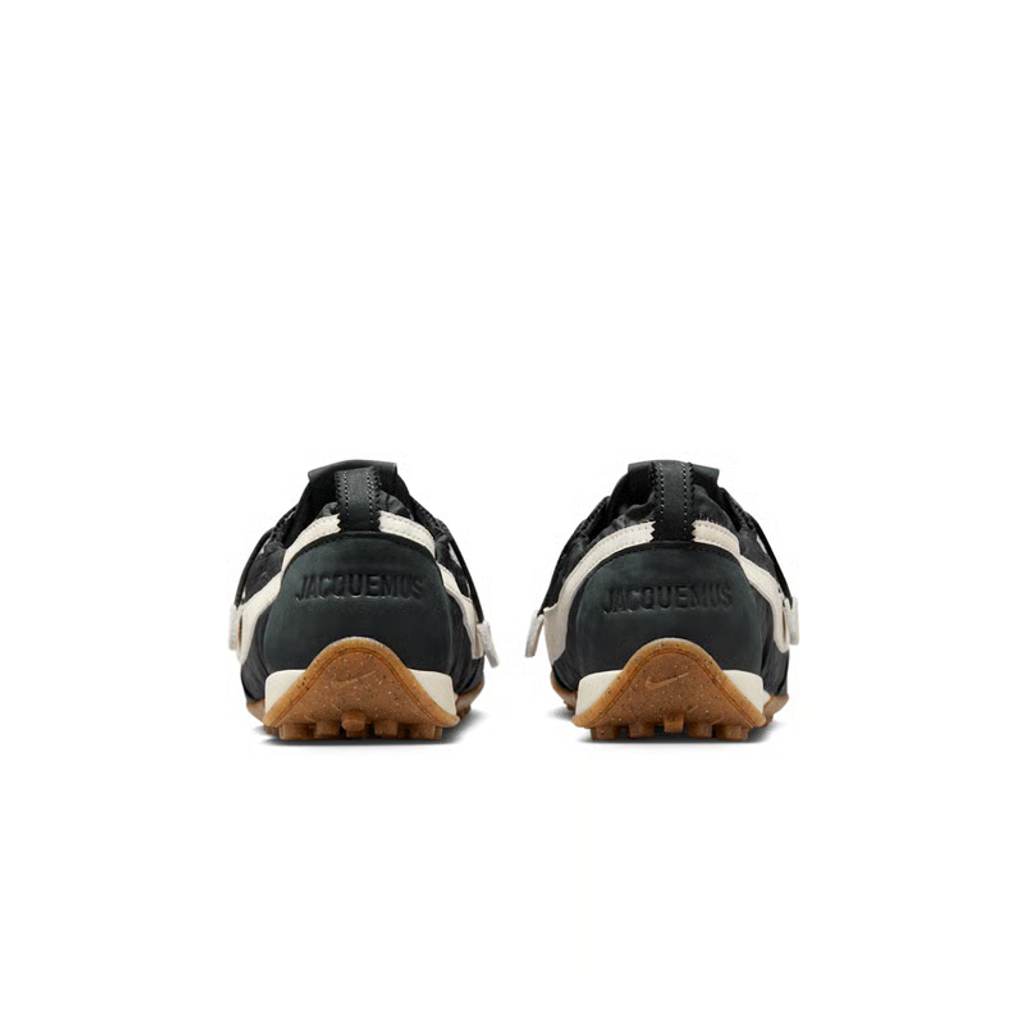 Side profile of Jacquemus x Nike Moon Shoe SP Off-Noir sneaker HV8547-001, featuring black ruched nylon, a leather Swoosh, and a gum rubber waffle sole. Available in Singapore and Malaysia.