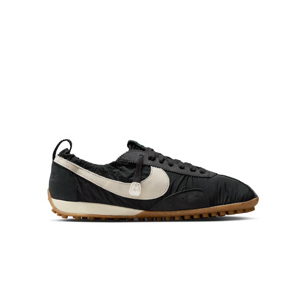 Side profile of Jacquemus x Nike Moon Shoe SP Off-Noir sneaker HV8547-001, featuring black ruched nylon, a leather Swoosh, and a gum rubber waffle sole. Available in Singapore and Malaysia.
