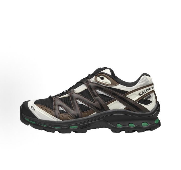 Side profile of Salomon XT-Quest GORE-TEX sneaker 491718 in Black Delicioso, featuring a waterproof dark mesh upper, Quicklace system, and rugged Contagrip outsole. Available in Singapore and Malaysia.