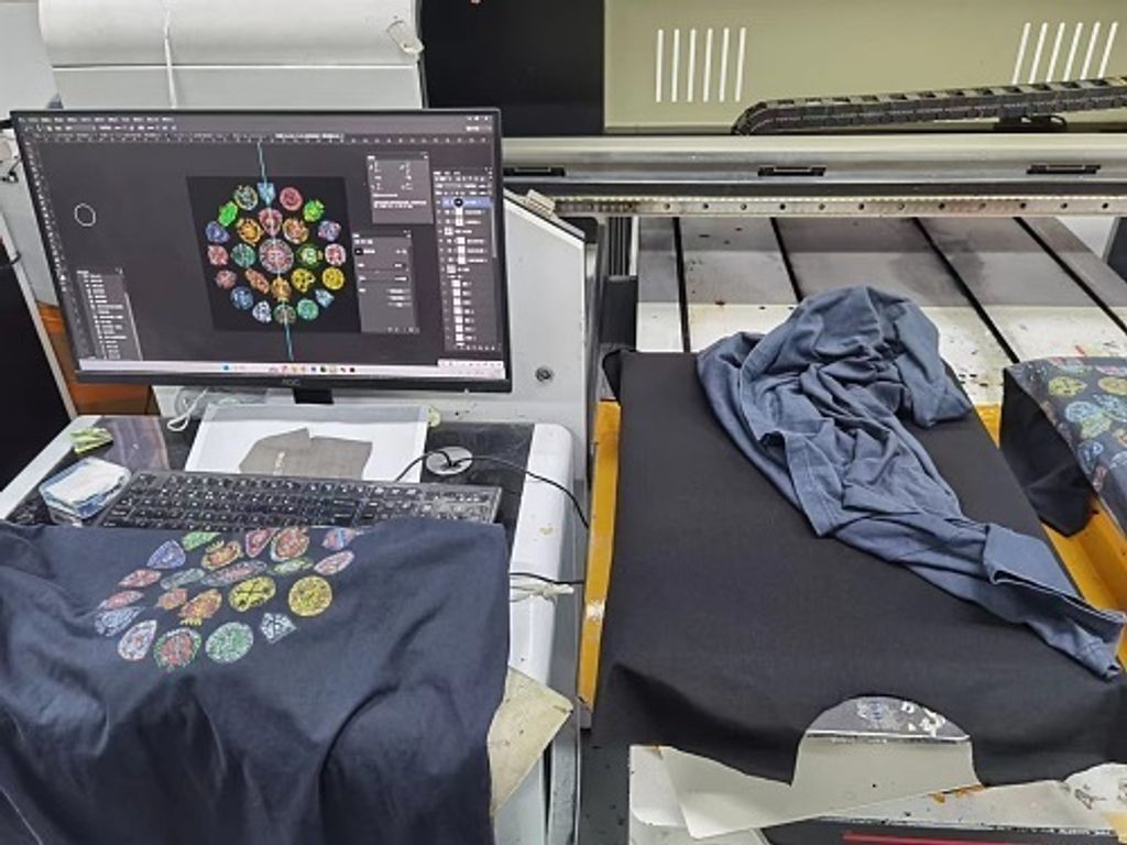 Front and back view of the Balenciaga Vintage Badge Print T-Shirt in washed black, featuring a circular vintage badge graphic on the front, a gothic logo on the back, and a relaxed oversized fit. Available in Singapore and Malaysia.