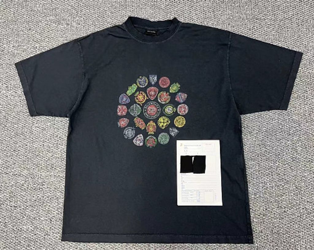 Front and back view of the Balenciaga Vintage Badge Print T-Shirt in washed black, featuring a circular vintage badge graphic on the front, a gothic logo on the back, and a relaxed oversized fit. Available in Singapore and Malaysia.