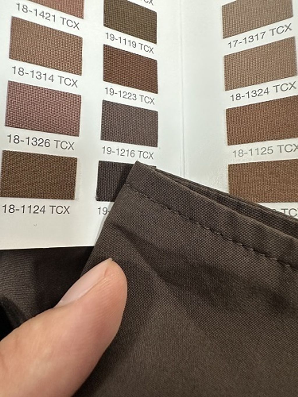 Front and back view of the Prada Inverted Triangle padded overshirt in dark espresso brown, featuring a chest pocket with subtle triangle logo, 200-count pure cotton fabric, and mother-of-pearl buttons. Available in Singapore and Malaysia.