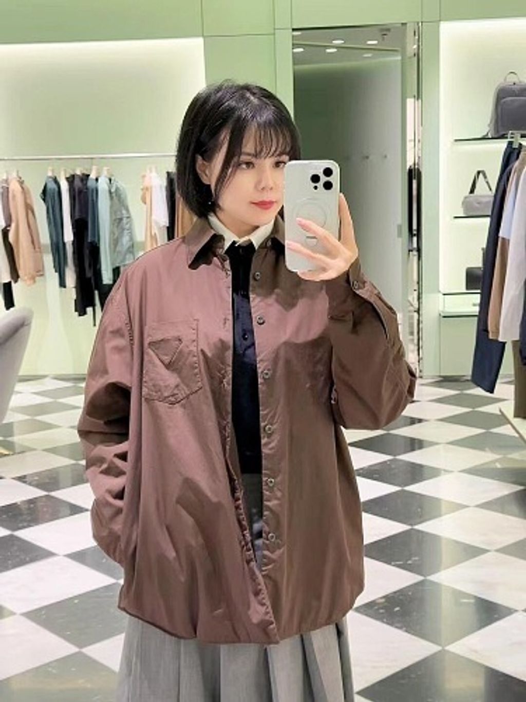 Front and back view of the Prada Inverted Triangle padded overshirt in dark espresso brown, featuring a chest pocket with subtle triangle logo, 200-count pure cotton fabric, and mother-of-pearl buttons. Available in Singapore and Malaysia.