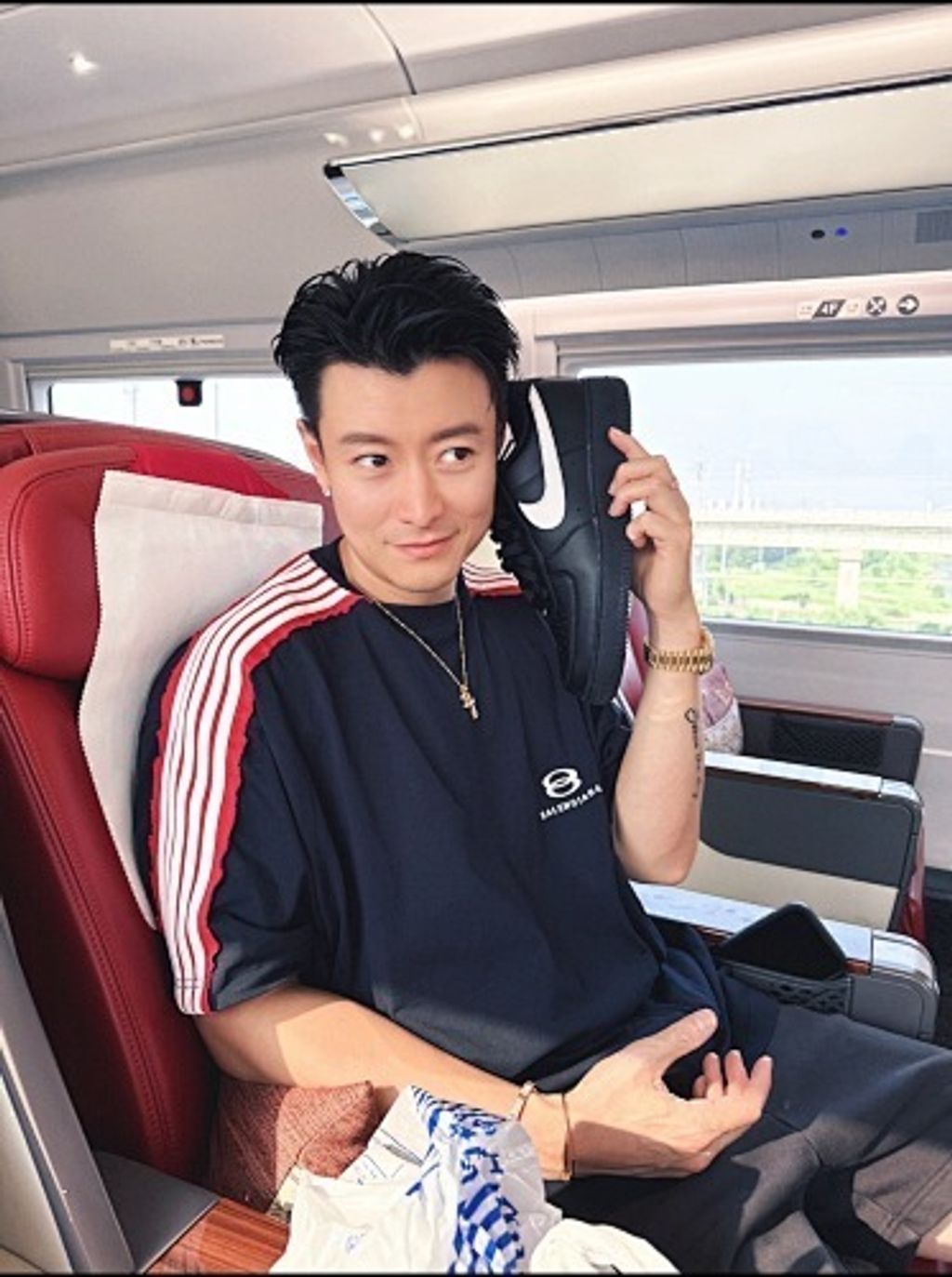 Front and back view of the Balenciaga Double Ring stripe t-shirt in black, featuring red and white racing stripes on the shoulders, a double-ring logo on the chest, and a relaxed oversized fit. Available in Singapore and Malaysia.