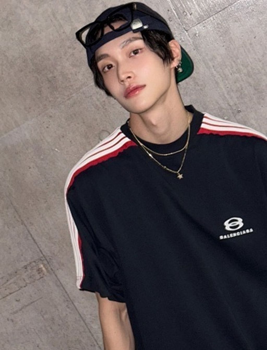 Front and back view of the Balenciaga Double Ring stripe t-shirt in black, featuring red and white racing stripes on the shoulders, a double-ring logo on the chest, and a relaxed oversized fit. Available in Singapore and Malaysia.