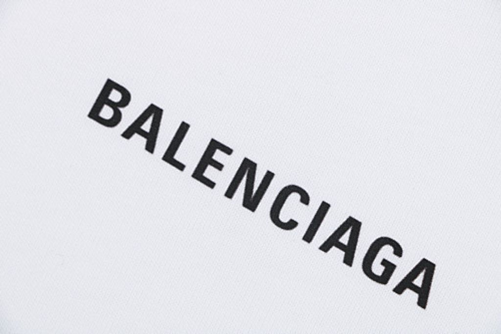 Front and back view of the Balenciaga oversized t-shirt in white, featuring a small black logo on the right chest, a large logo across the back, and a relaxed drop-shoulder fit. Available in Singapore and Malaysia.