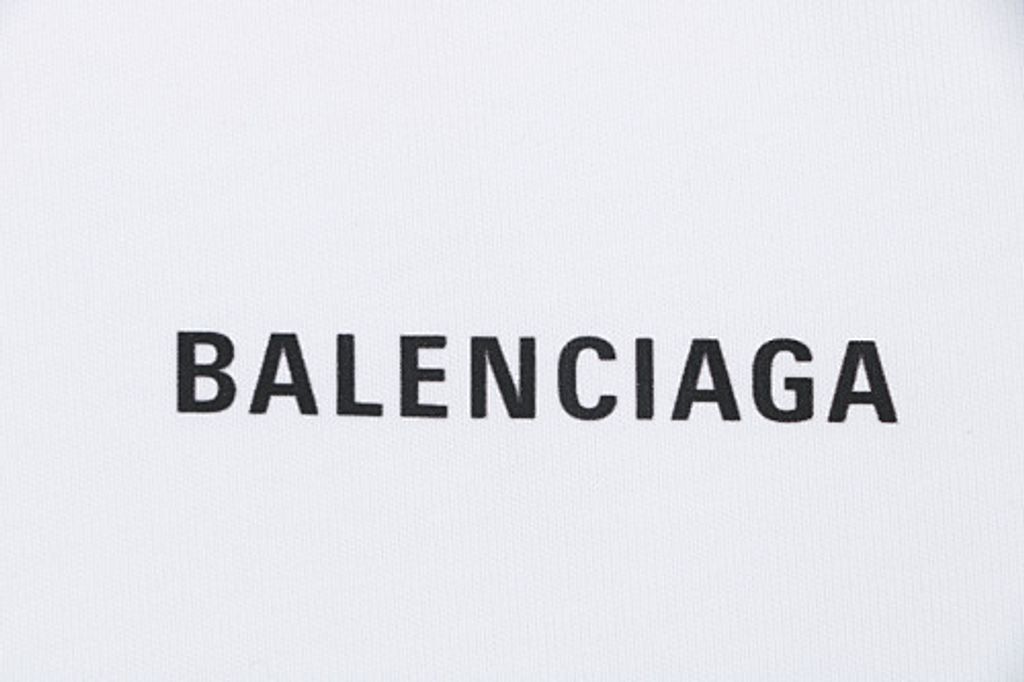 Front and back view of the Balenciaga oversized t-shirt in white, featuring a small black logo on the right chest, a large logo across the back, and a relaxed drop-shoulder fit. Available in Singapore and Malaysia.