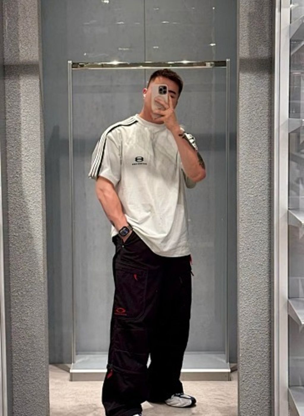 Front and back view of the Balenciaga Double Ring stripe t-shirt in off-white, featuring black and white racing stripes on the shoulders, a double-ring logo on the chest, and a relaxed oversized fit. Available in Singapore and Malaysia.