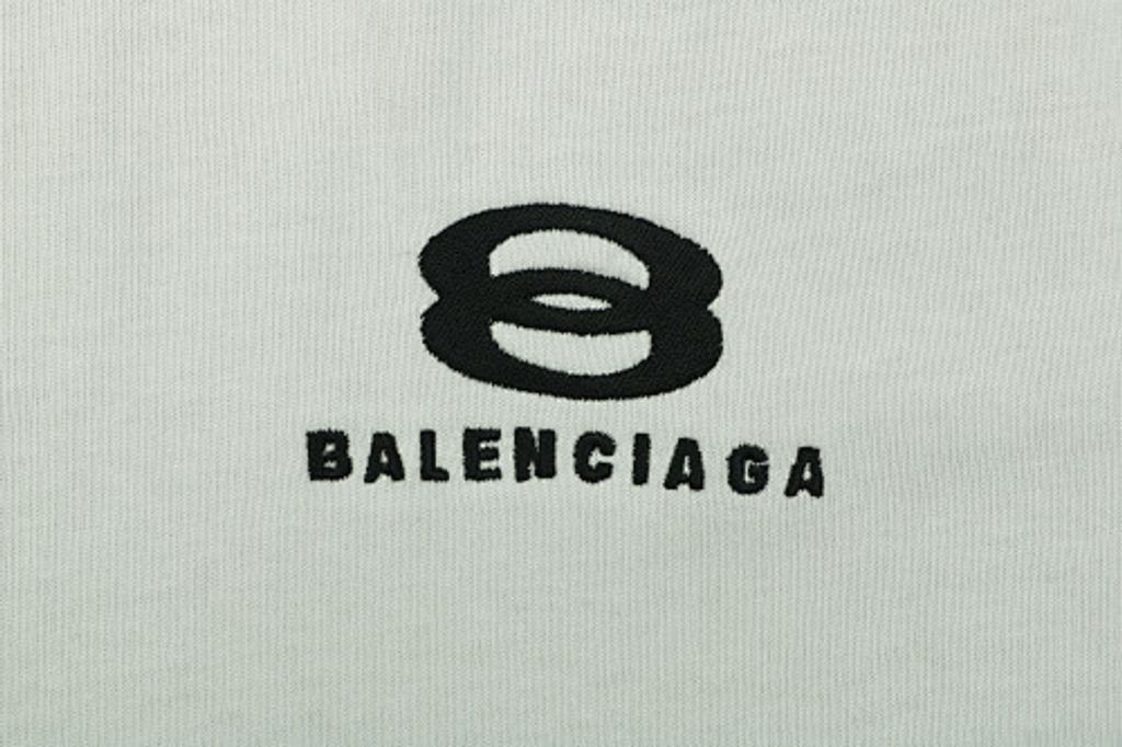 Front and back view of the Balenciaga Double Ring stripe t-shirt in off-white, featuring black and white racing stripes on the shoulders, a double-ring logo on the chest, and a relaxed oversized fit. Available in Singapore and Malaysia.