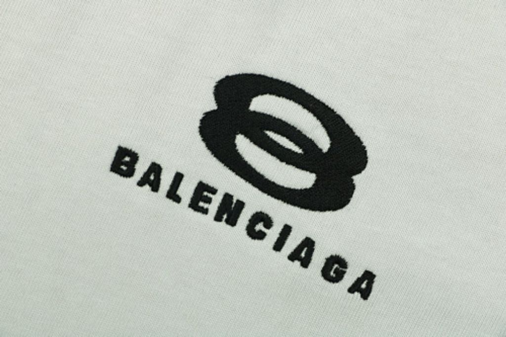 Front and back view of the Balenciaga Double Ring stripe t-shirt in off-white, featuring black and white racing stripes on the shoulders, a double-ring logo on the chest, and a relaxed oversized fit. Available in Singapore and Malaysia.