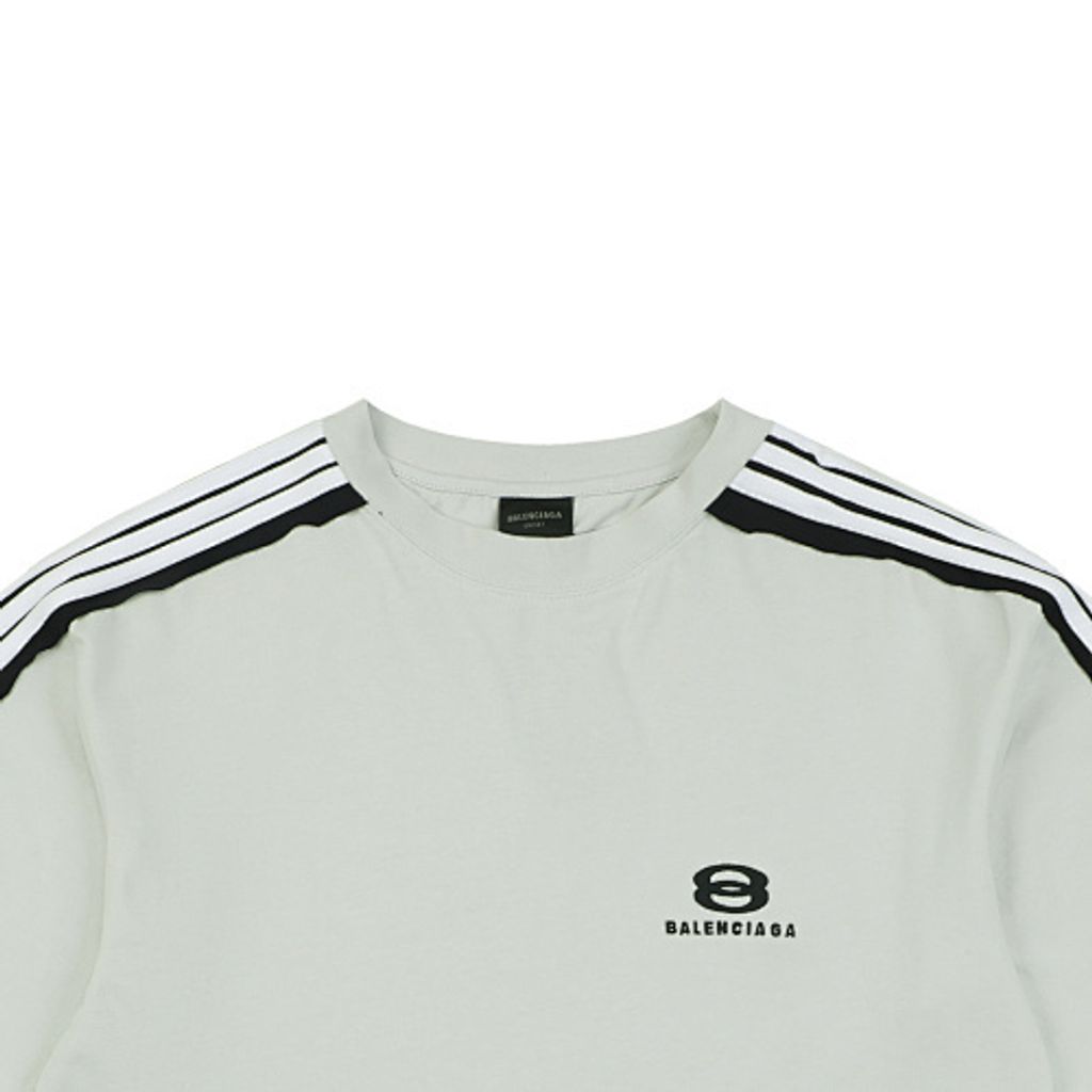 Front and back view of the Balenciaga Double Ring stripe t-shirt in off-white, featuring black and white racing stripes on the shoulders, a double-ring logo on the chest, and a relaxed oversized fit. Available in Singapore and Malaysia.