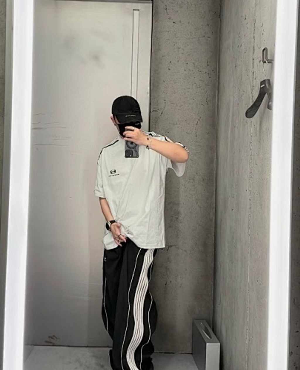 Front and back view of the Balenciaga Double Ring stripe t-shirt in off-white, featuring black and white racing stripes on the shoulders, a double-ring logo on the chest, and a relaxed oversized fit. Available in Singapore and Malaysia.