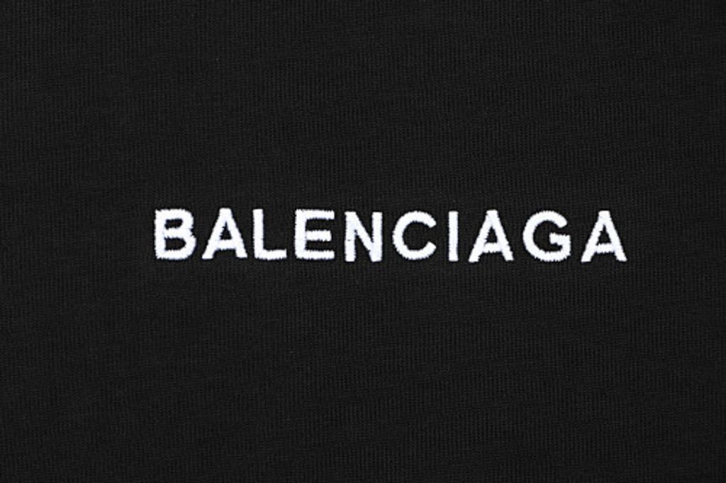 Front and back view of the Balenciaga Double Lion Emblem t-shirt in black, featuring a center chest logo, embroidered lion crests on the sleeves, and a relaxed oversized fit. Available in Singapore and Malaysia.