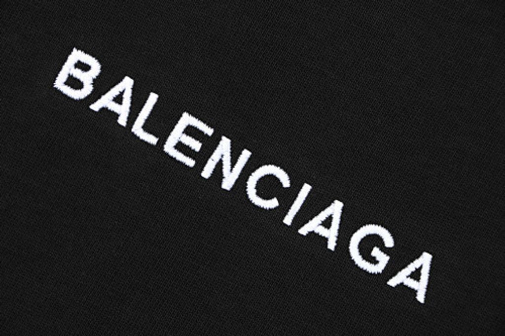Front and back view of the Balenciaga Double Lion Emblem t-shirt in black, featuring a center chest logo, embroidered lion crests on the sleeves, and a relaxed oversized fit. Available in Singapore and Malaysia.