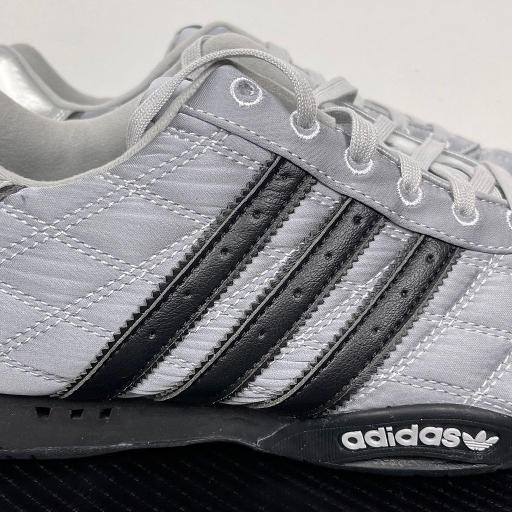 Side profile of women's adidas Adi Racer Low sneaker JS0284, featuring a sleek metallic silver upper, black 3-stripes, and a low-profile motorsport rubber outsole. Available in Singapore and Malaysia..jpg