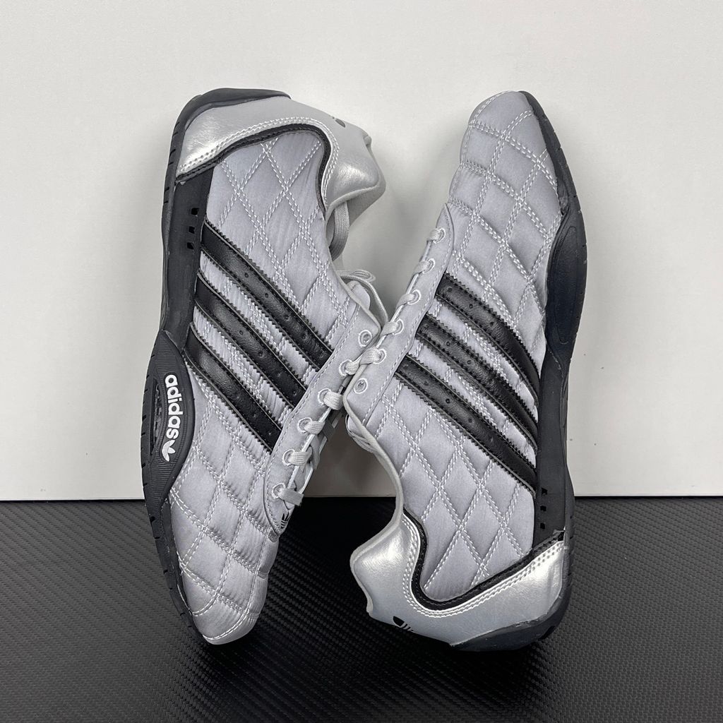 Side profile of women's adidas Adi Racer Low sneaker JS0284, featuring a sleek metallic silver upper, black 3-stripes, and a low-profile motorsport rubber outsole. Available in Singapore and Malaysia..jpg