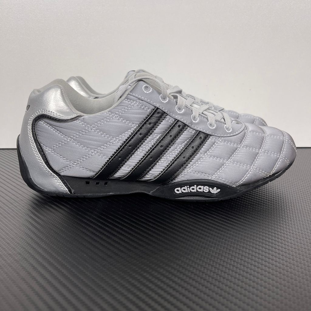 Side profile of women's adidas Adi Racer Low sneaker JS0284, featuring a sleek metallic silver upper, black 3-stripes, and a low-profile motorsport rubber outsole. Available in Singapore and Malaysia..jpg