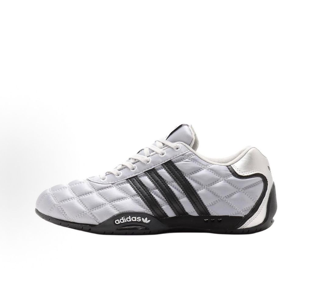 Side profile of women's adidas Adi Racer Low sneaker JS0284, featuring a sleek metallic silver upper, black 3-stripes, and a low-profile motorsport rubber outsole. Available in Singapore and Malaysia.