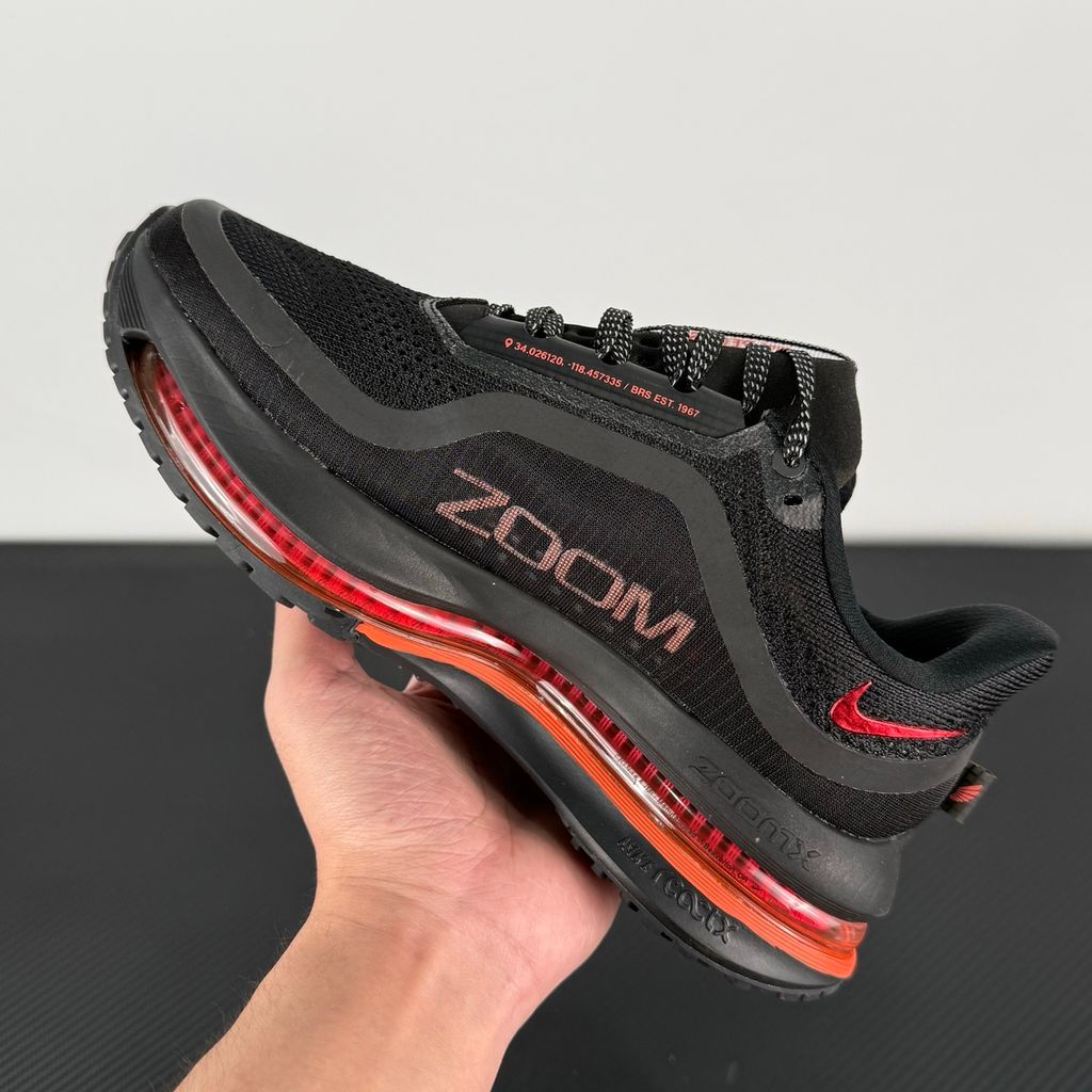 Side profile of the Nike Air Zoom Pegasus Premium running shoe HQ2593-010 in Hot Lava, featuring a vibrant red-orange knit upper, a sculpted visible Zoom Air unit, and a thick ZoomX midsole. Available in Singapore and Malaysia.