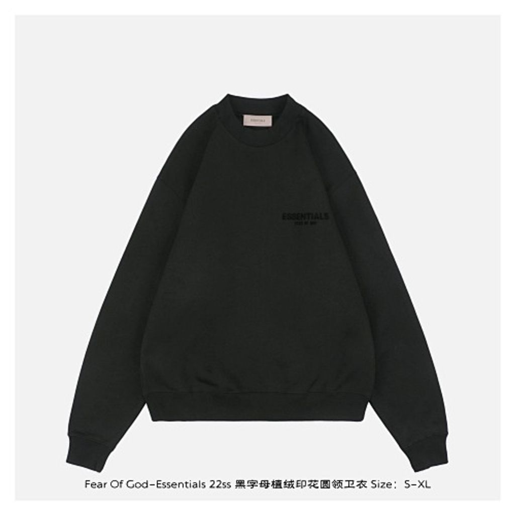 Front and back view of the black Fear of God Essentials crewneck sweatshirt, featuring a tonal black flocked logo on the chest and back, with a relaxed drop-shoulder fit. Available in Singapore and Malaysia.