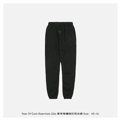 Front and back view of the black Fear of God Essentials sweatpants, featuring a tonal black flocked logo on the left leg, elongated cotton drawstrings, and a relaxed tapered fit. Available in Singapore and Malaysia.