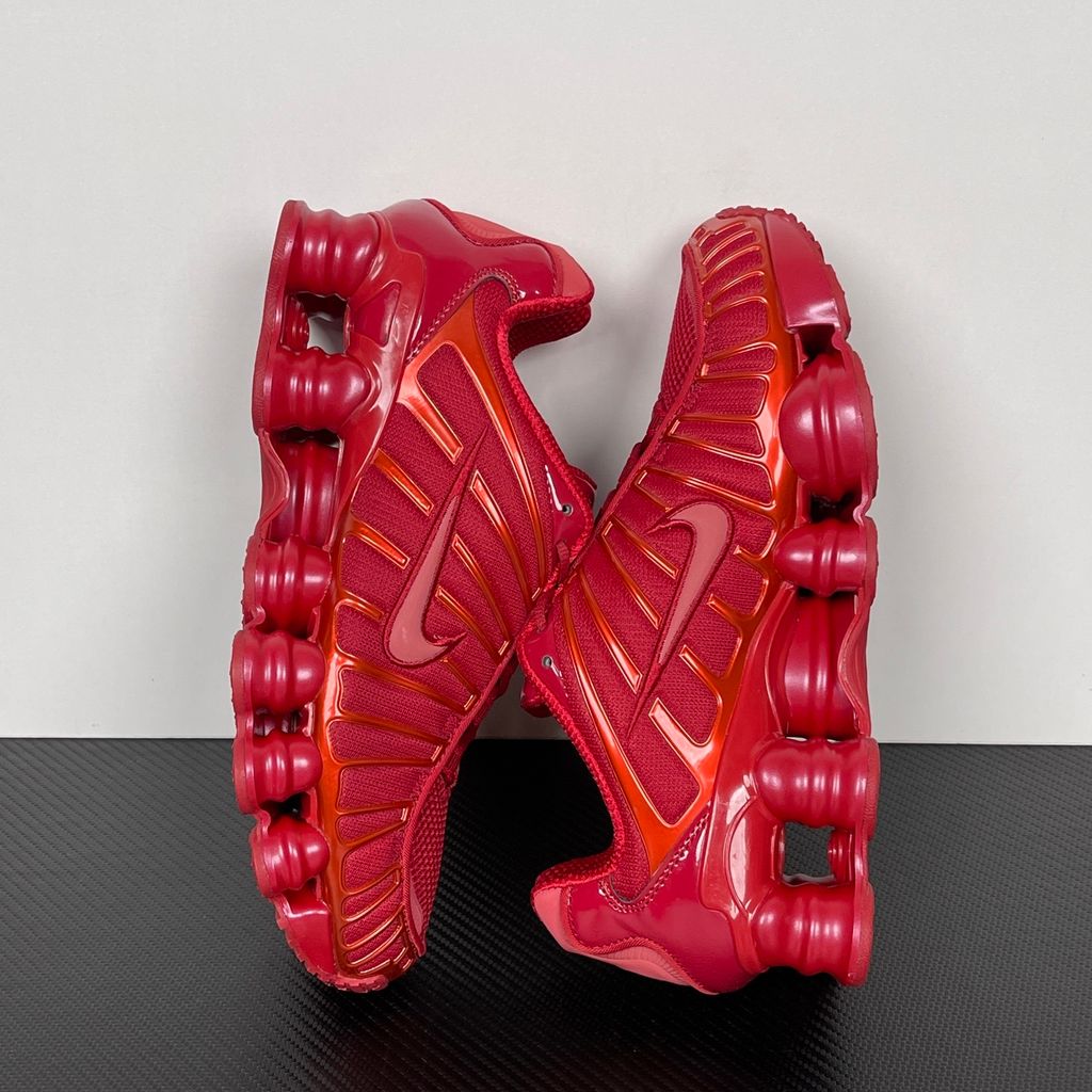 Side profile of the Nike Shox TL sneaker IB1087-600 in Gym Red, featuring a breathable red mesh upper, structural white TPU cage overlays, and full-length visible Shox column cushioning. Available in Singapore and Malaysia..jpg