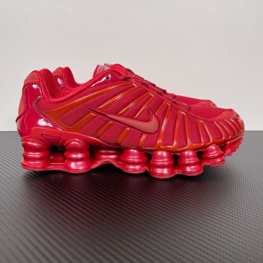 Side profile of the Nike Shox TL sneaker IB1087-600 in Gym Red, featuring a breathable red mesh upper, structural white TPU cage overlays, and full-length visible Shox column cushioning. Available in Singapore and Malaysia..jpg