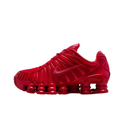 Side profile of the Nike Shox TL sneaker IB1087-600 in Gym Red, featuring a breathable red mesh upper, structural white TPU cage overlays, and full-length visible Shox column cushioning. Available in Singapore and Malaysia.