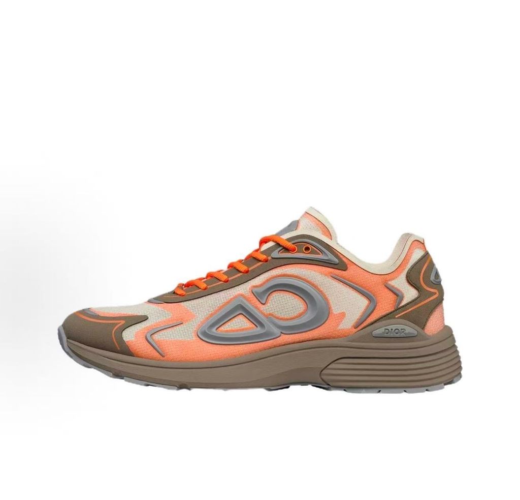 Side profile of the 26SS Dior B30 sneaker in orange and grey, featuring breathable technical mesh, reflective rubber CD30 signatures, and a sculpted lightweight rubber and EVA outsole. Available in Singapore and Malaysia.