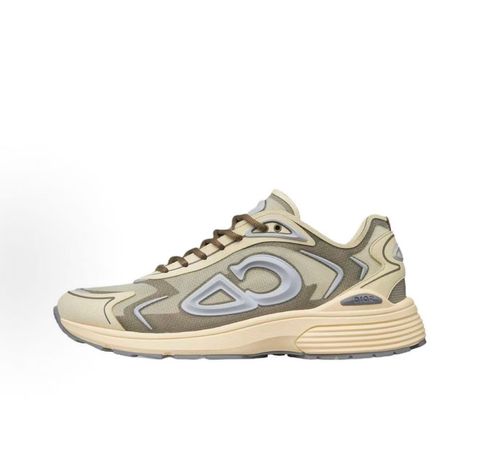 Side profile of the 26SS Dior B30 sneaker in orange and grey, featuring breathable technical mesh, reflective rubber CD30 signatures, and a sculpted lightweight rubber and EVA outsole. Available in Singapore and Malaysia.